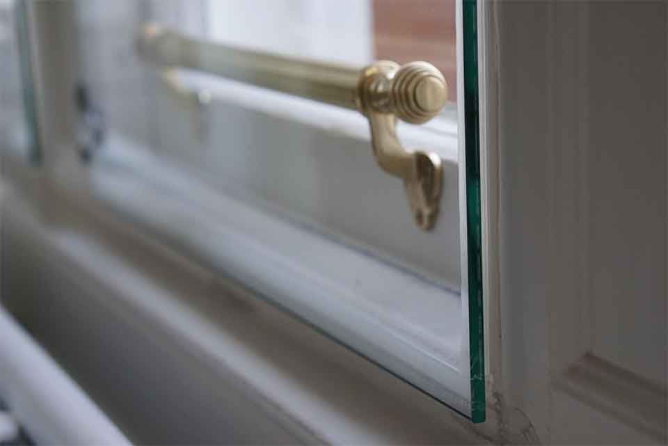 Hinged frameless secondary window