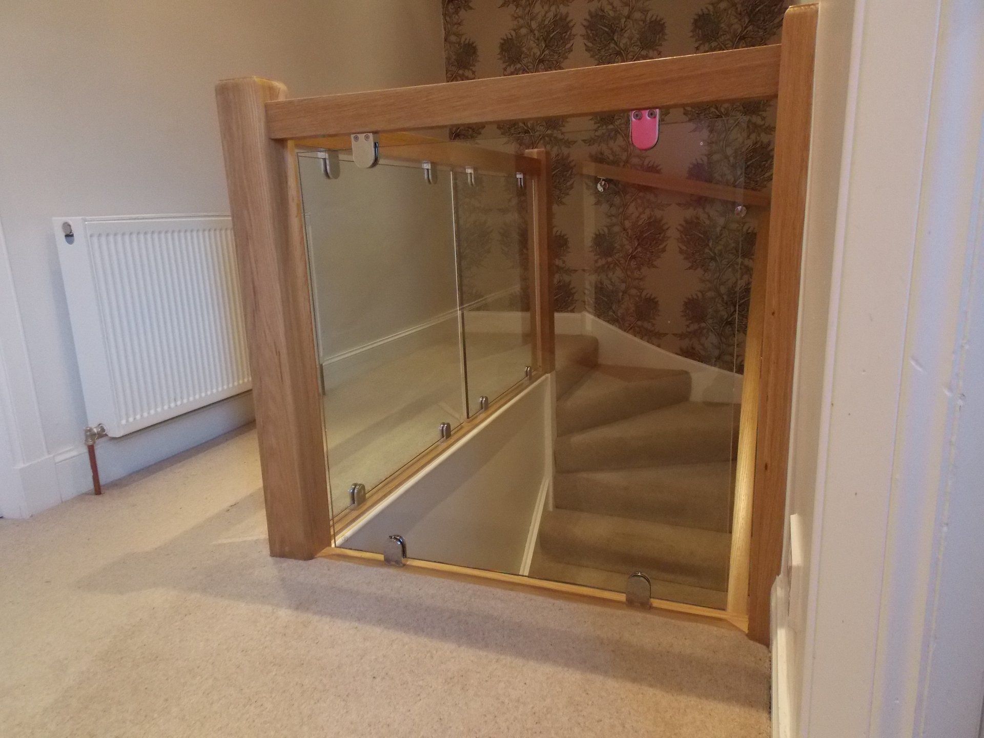 Oak and glass balustrade and oak handrail mounted on chrome brackets example 7