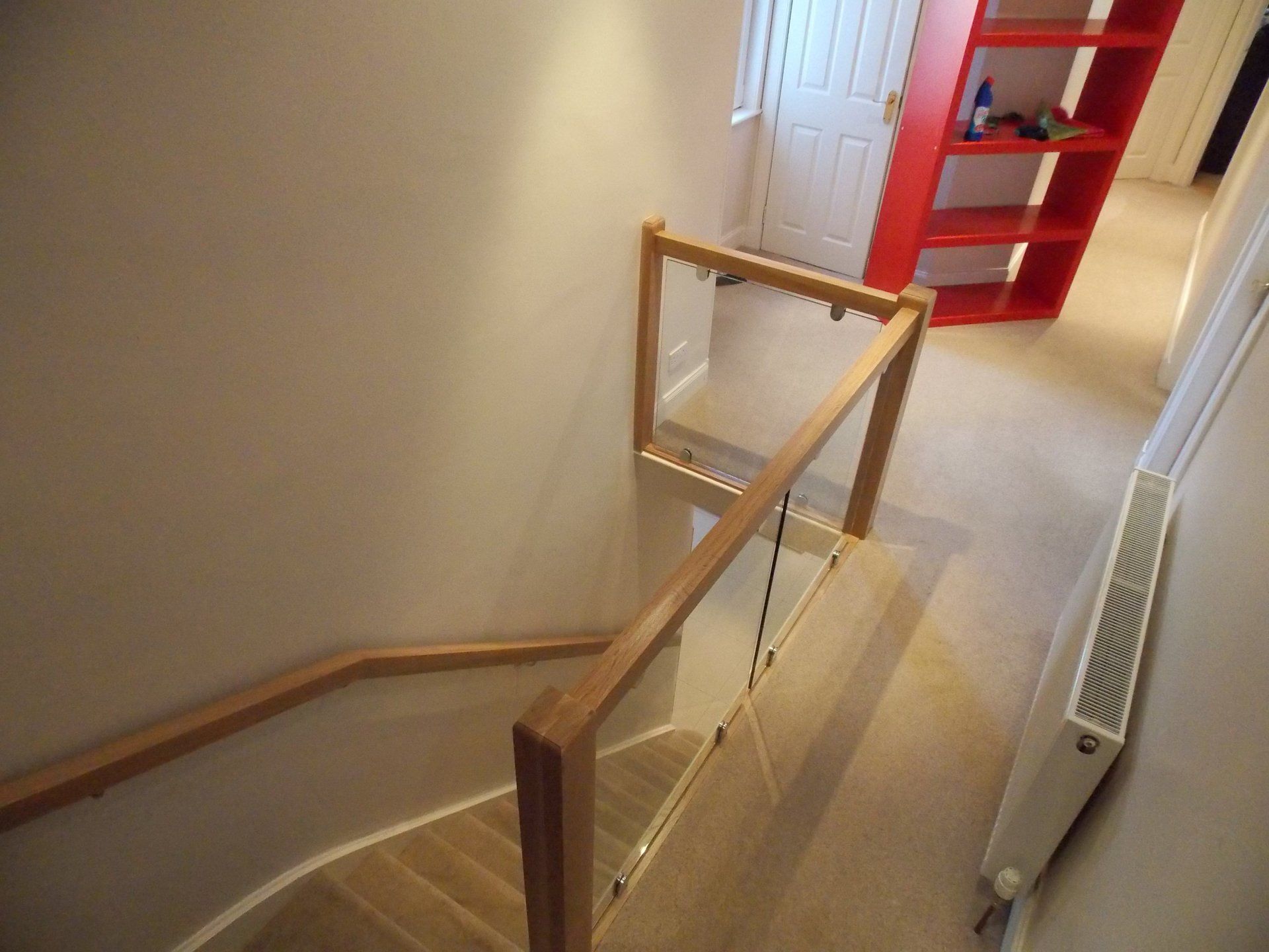 Oak and glass balustrade and oak handrail mounted on chrome brackets example 6