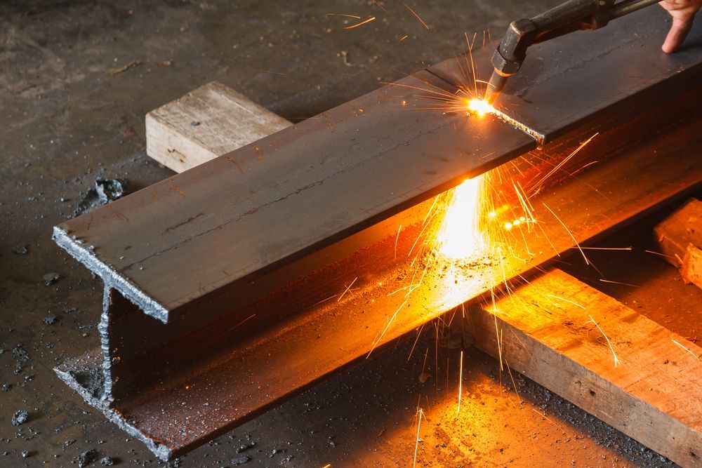 Steel Beam Being Cut with A Torch, Sparks Flying — Chris Horton Manufacturing in Bathurst, NSW