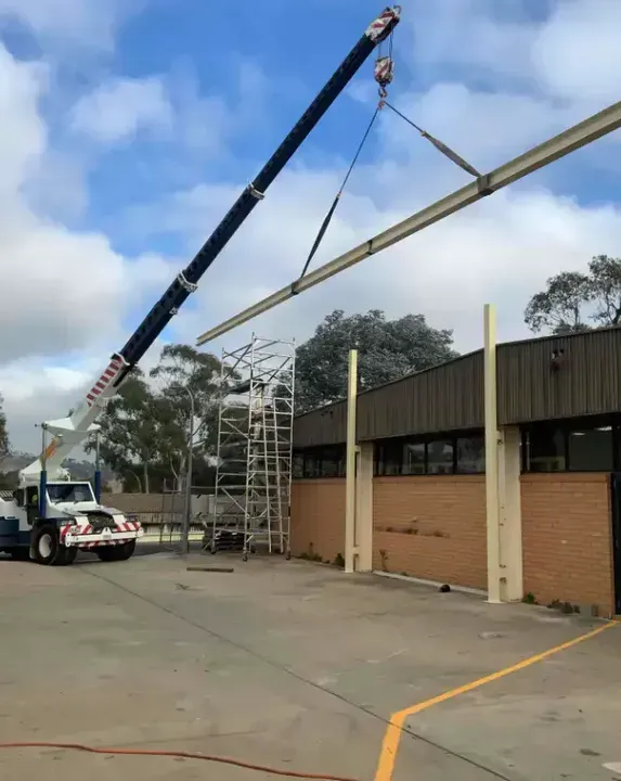 Crane lifting a steel beam — Chris Horton Manufacturing in Bathurst, NSW