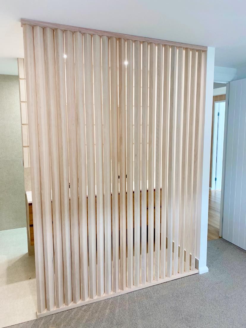 Wooden slat room divider in a light-colored interior, providing partial privacy. — Barrington Coast Homes in Tallwoods, NSW