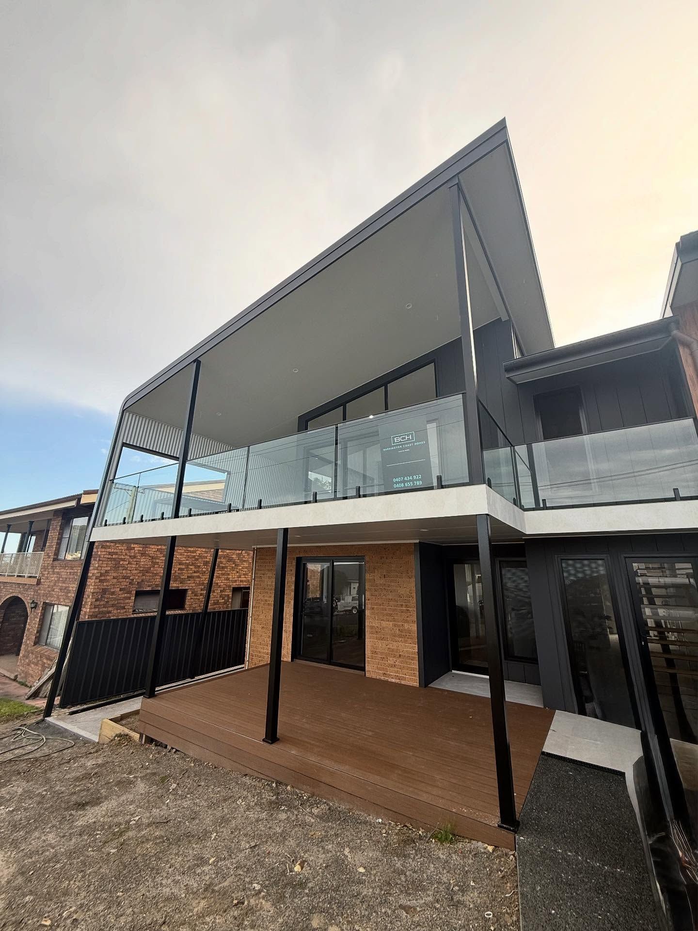 Modern Two-story House With a Deck, Glass Railings — Barrington Coast Homes in Forster, NSW