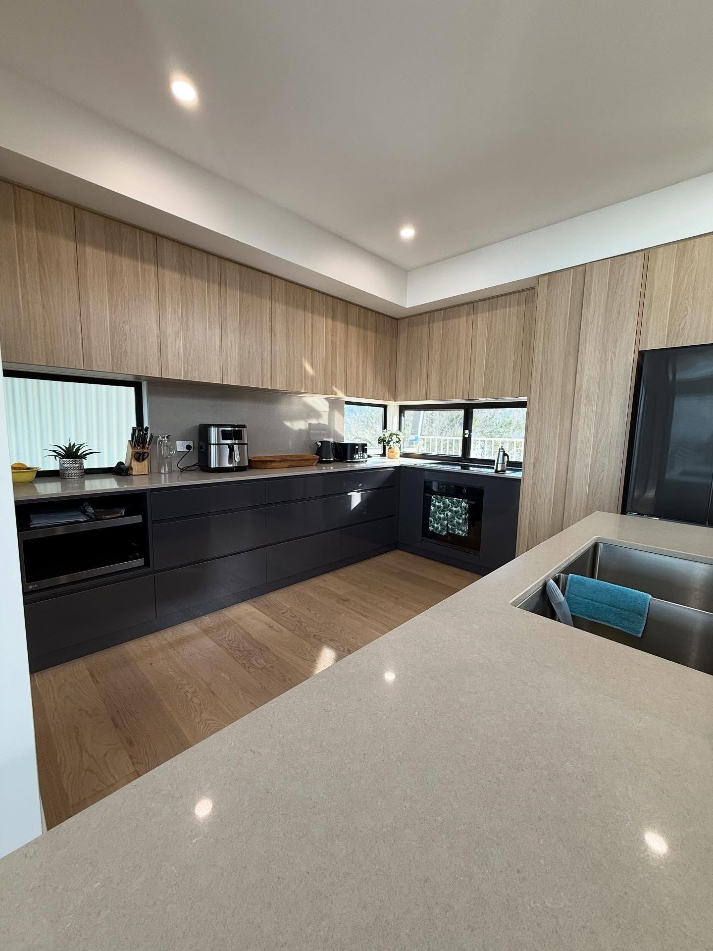 Modern Kitchen With Light Wood Cabinets — Barrington Coast Homes in Forster, NSW