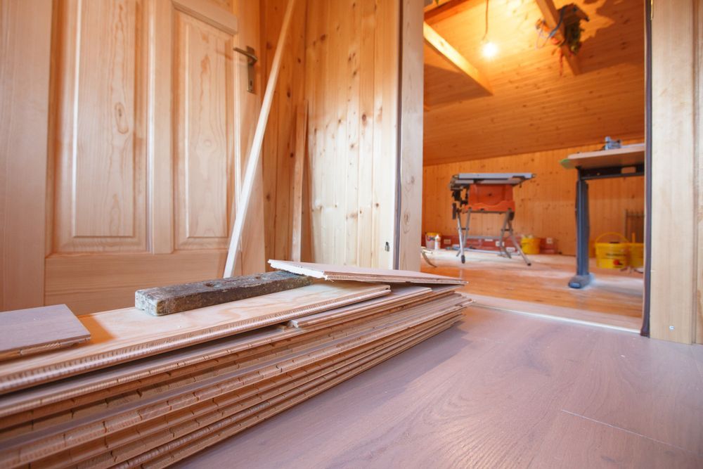 Wood-paneled Room Under Construction, With Stacked Flooring Boards — Barrington Coast Homes in Nabiac, NSW