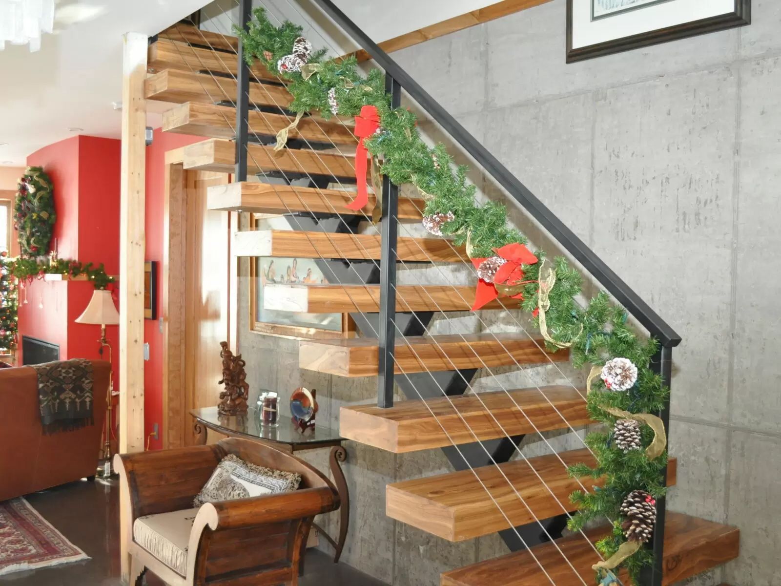 A wooden staircase decorated with christmas decorations in a living room