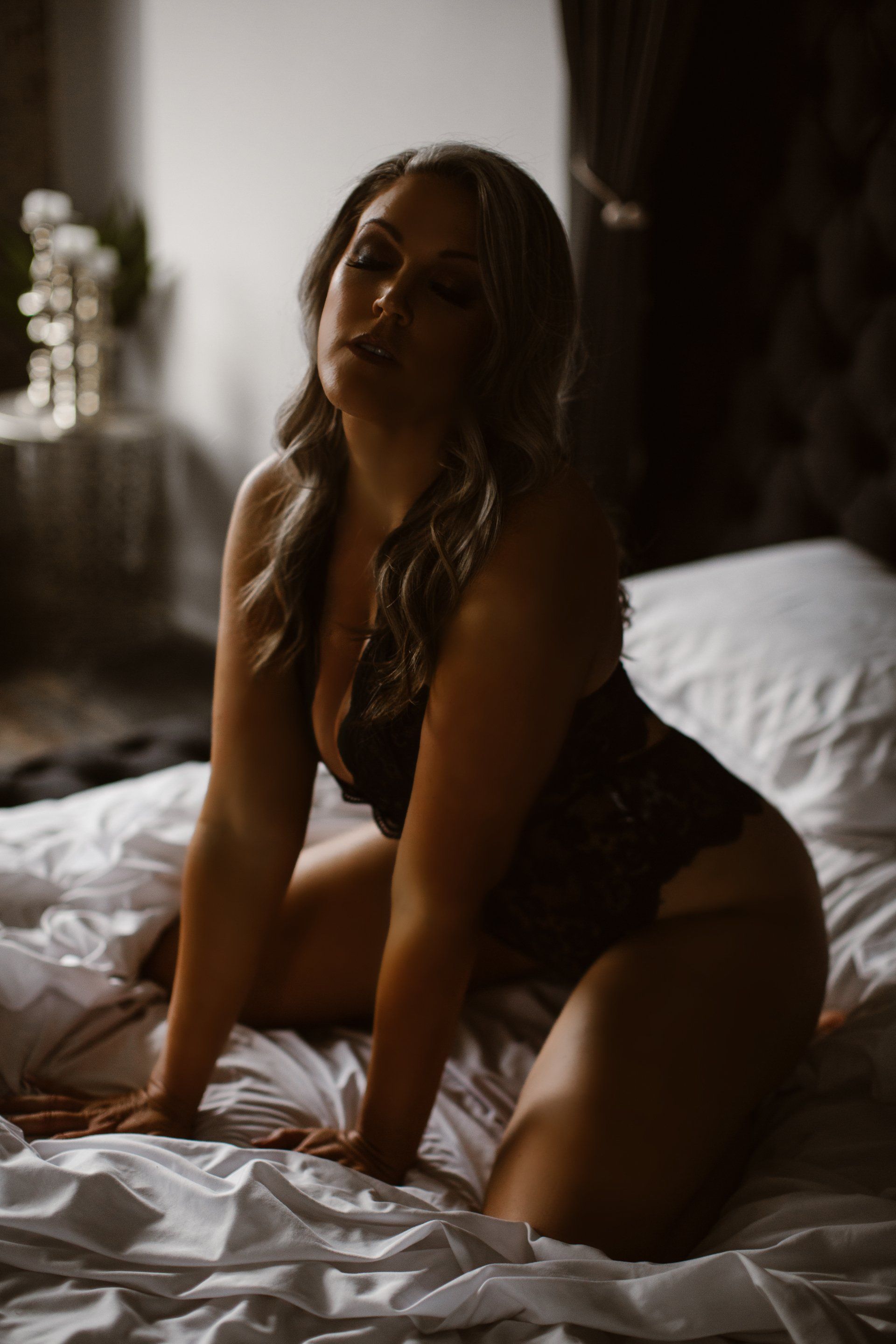 Hand on bed boudoir pose