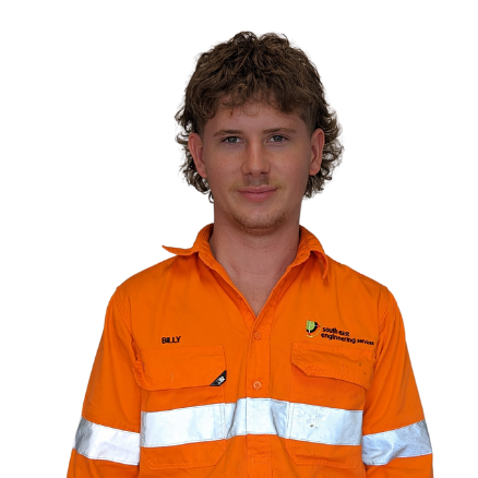 A man wearing an orange shirt with the name billy on it