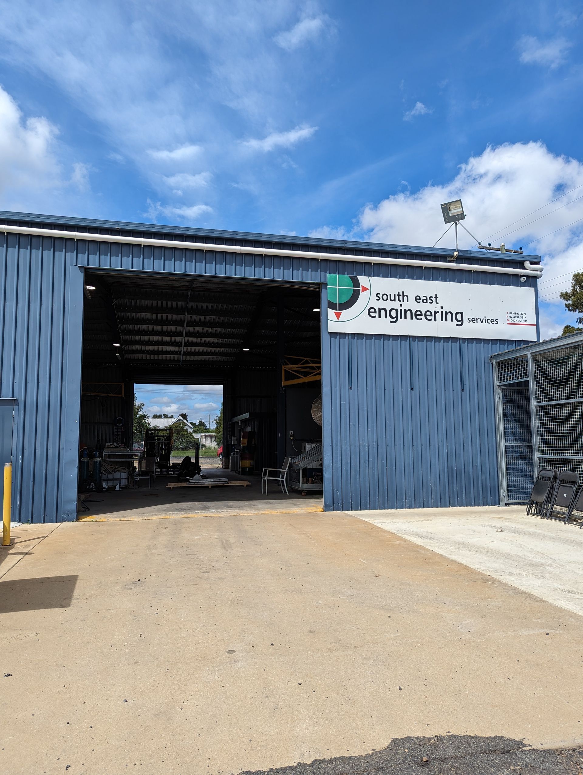 A blue building with a sign that says 