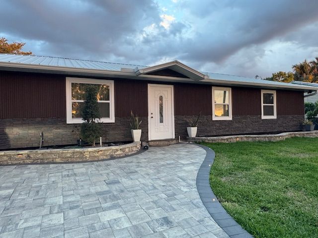 Exterior home renovation with decorative stone and modern siding in Fort Myers Florida