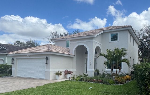 Two - story home exterior repaint project in Fort Myers Florida by Abuelo's Painting