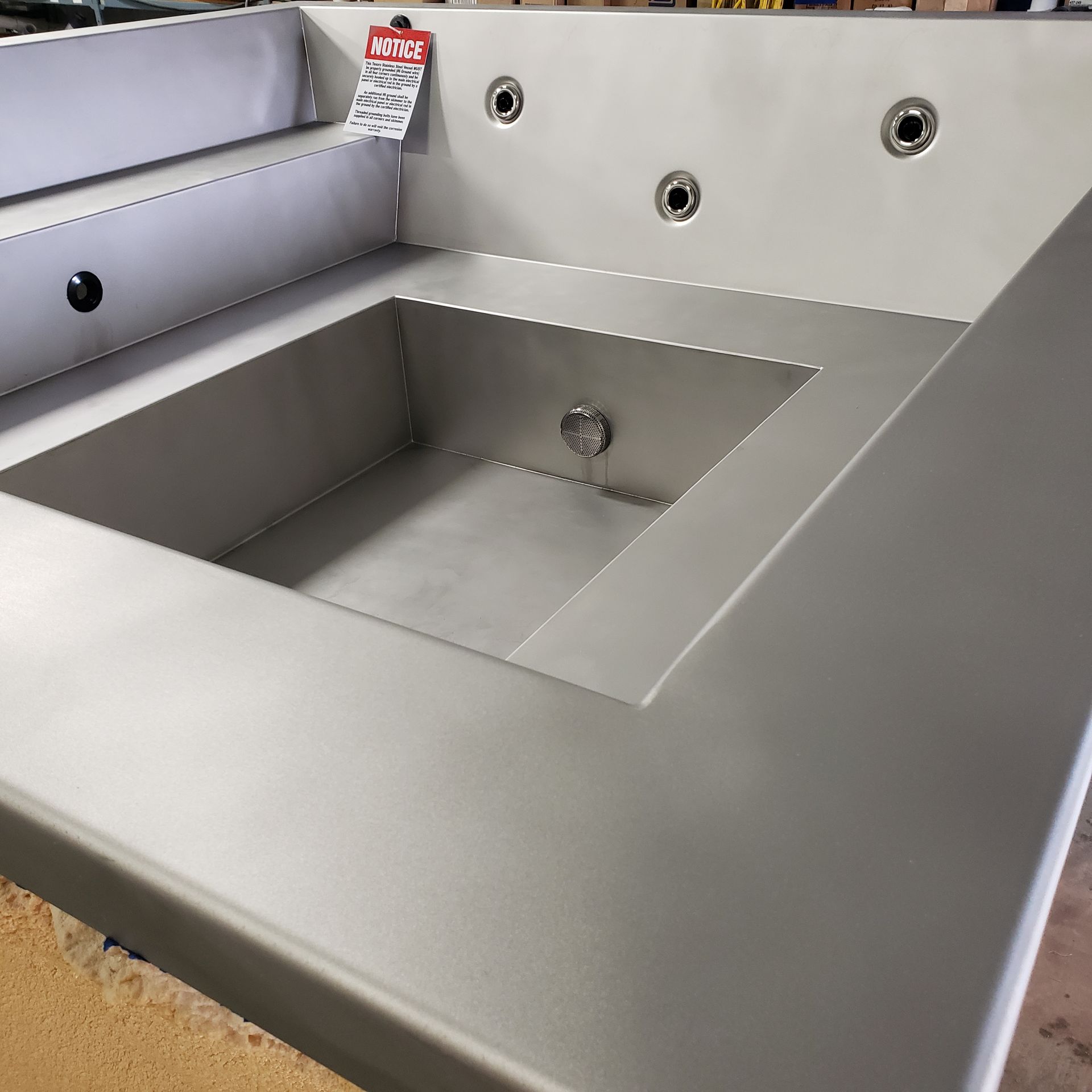 Stainless steel rectangular outdoor hot tub.