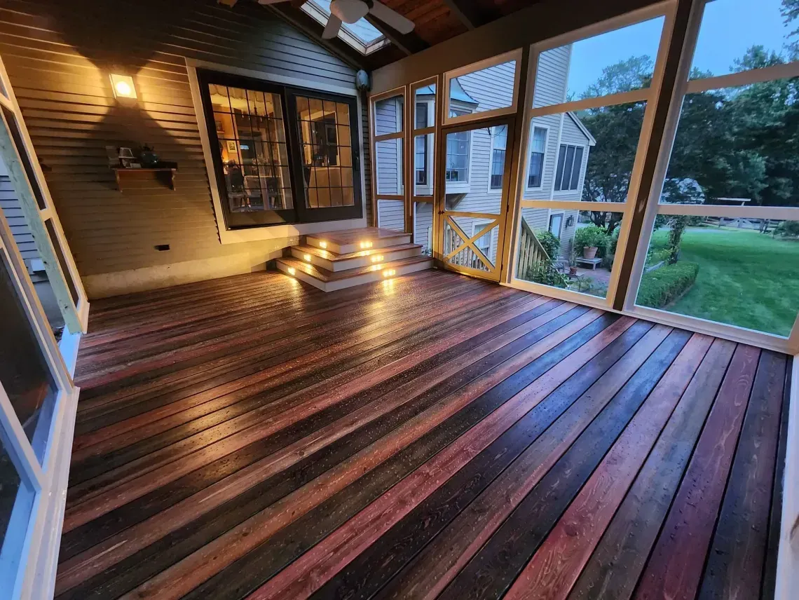A wall covered in horizontal wooden planks of varying widths in shades of white, natural brown, and grey.