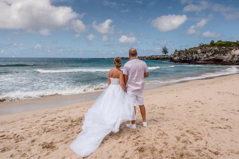 couple looking out at water on beach