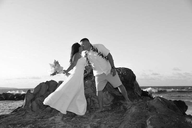 couple on rocks by beach