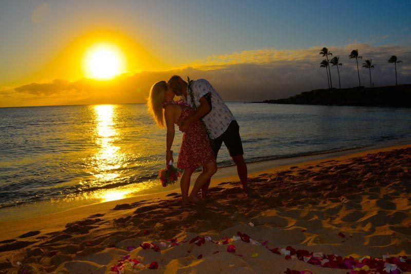 couple on beach with sun setting