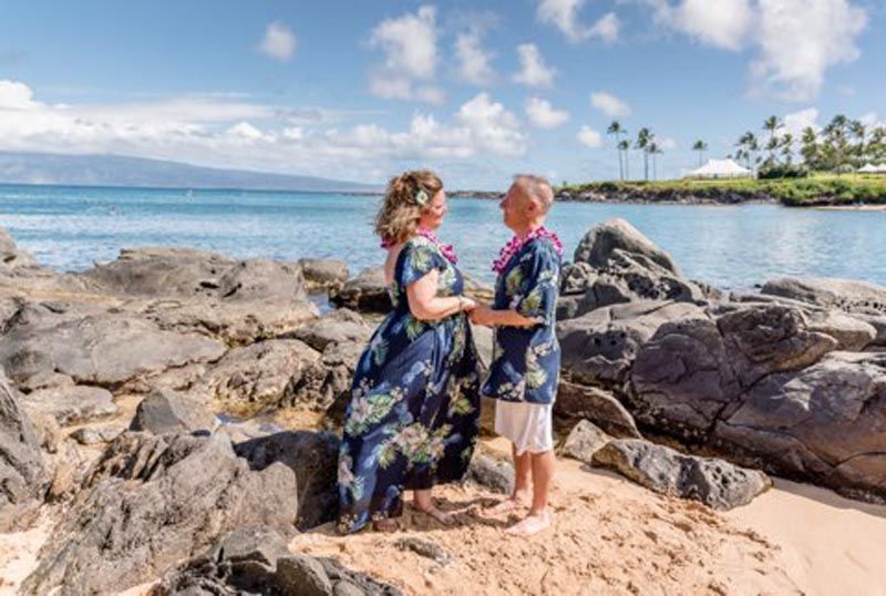 couple holding hands on beach