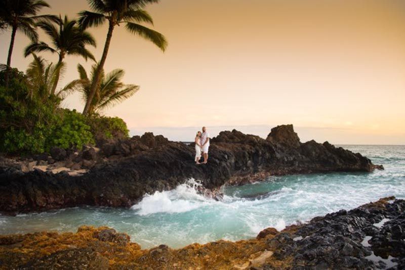 couple on rocks near water
