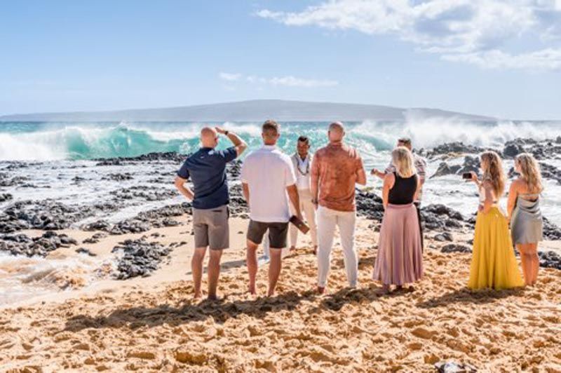 4 people looking out at beach