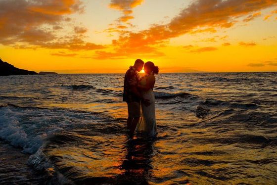 couple in water at sunset