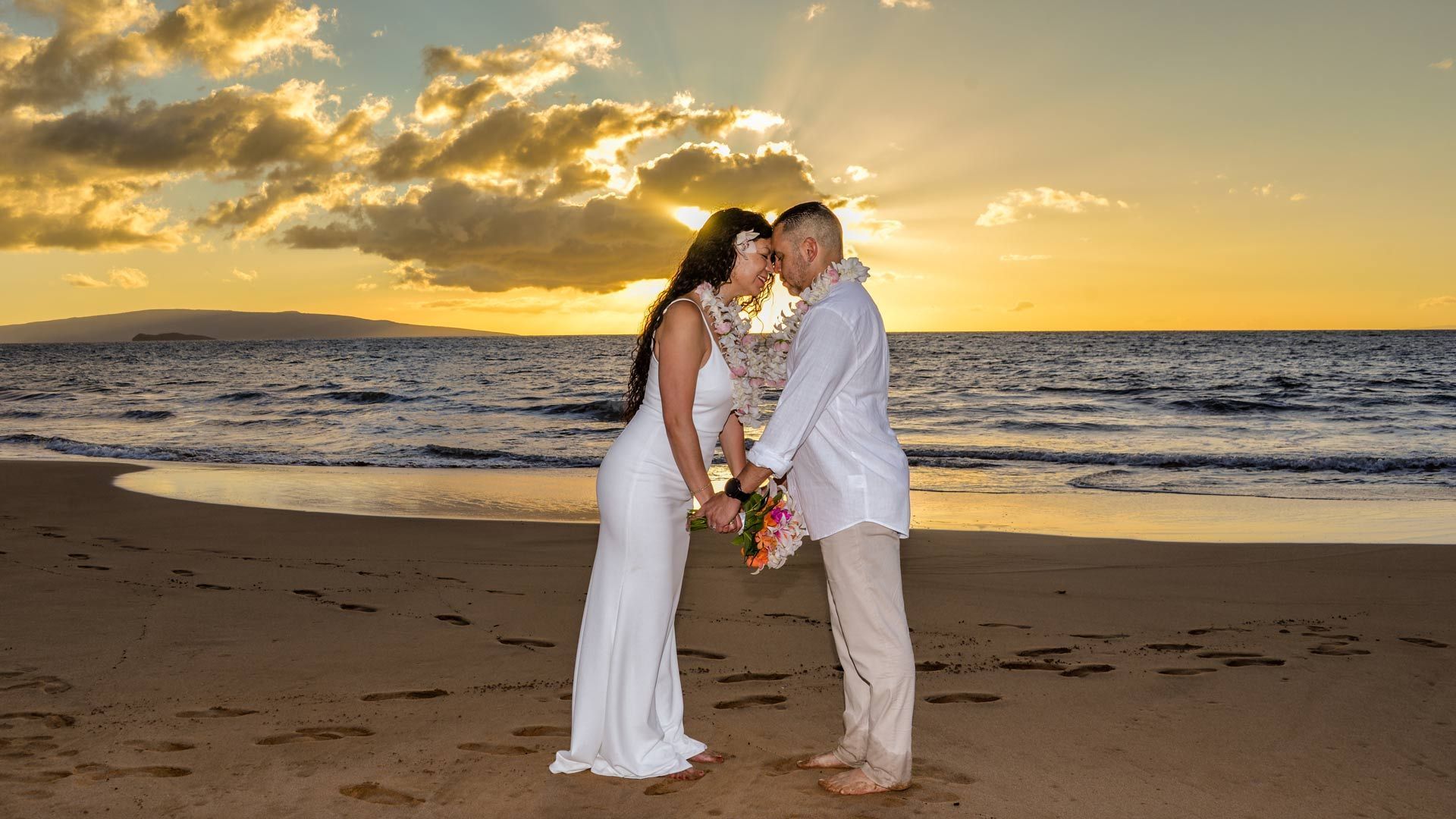 couple on hawaii beach with champagne flutes