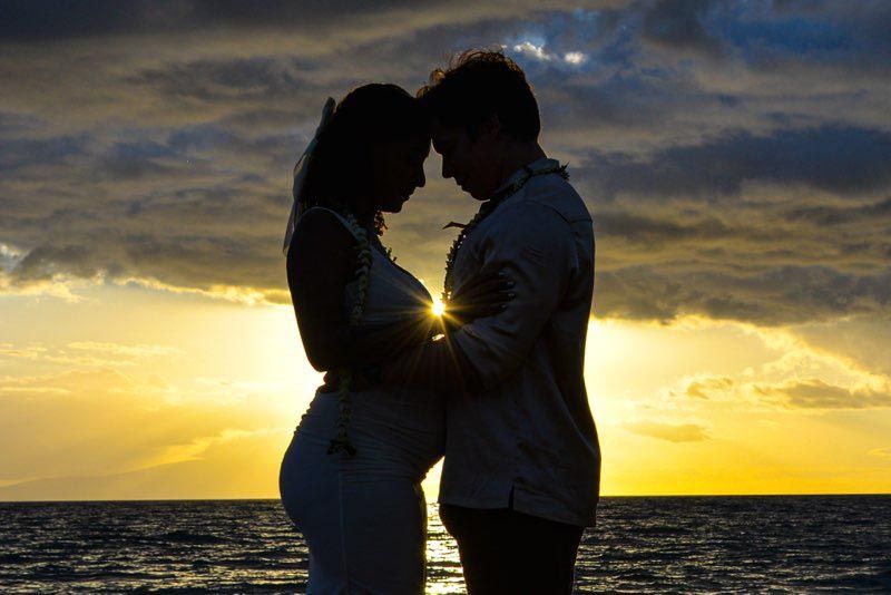 silhouette of happy couple on beach
