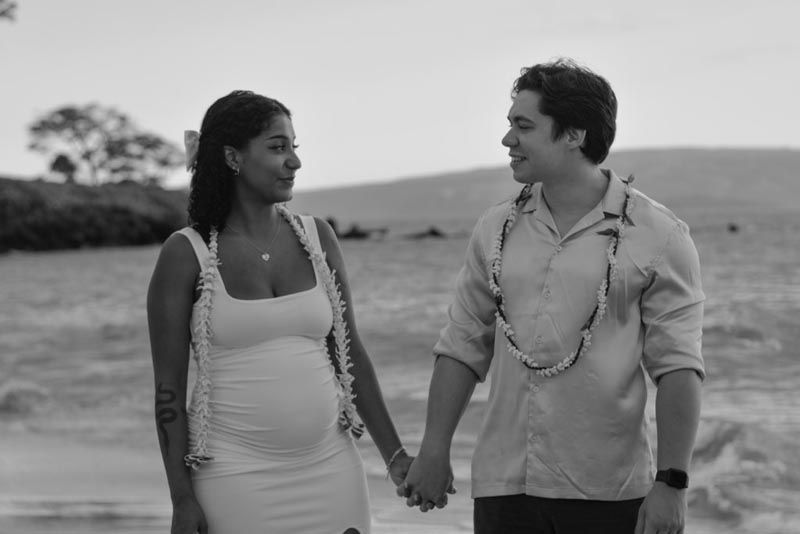 couple holding hands looking at each other