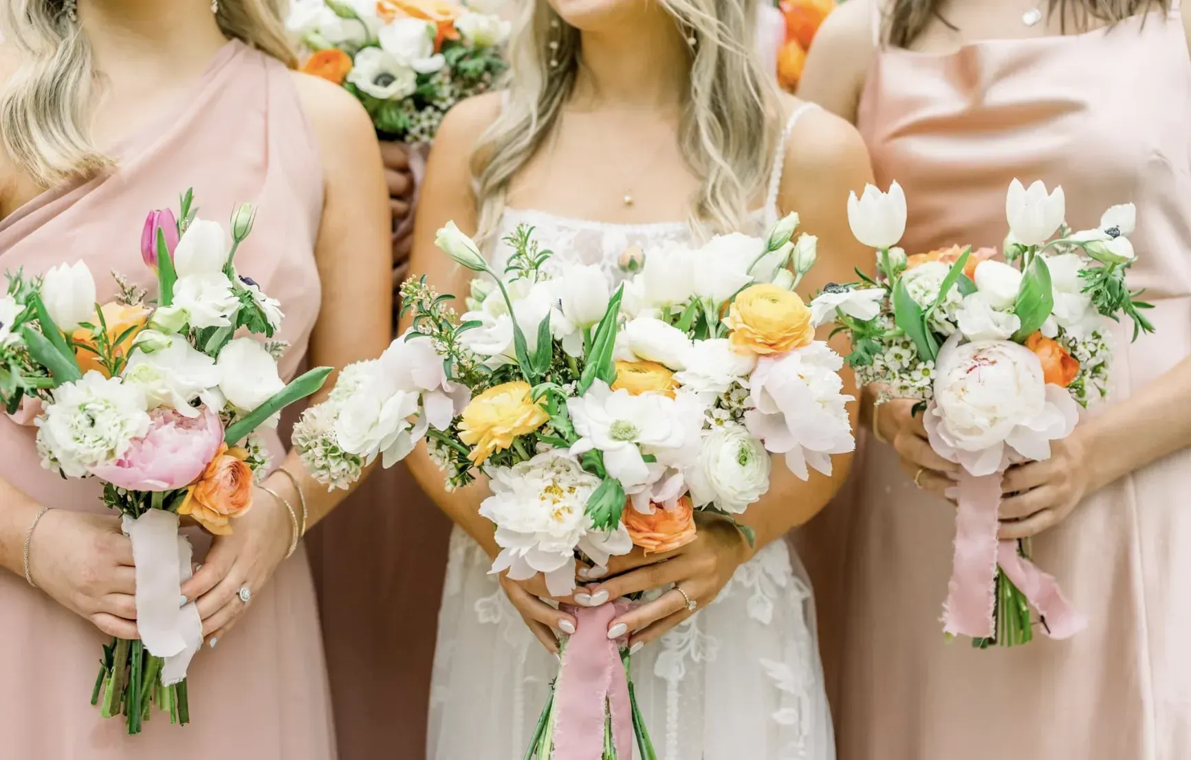 Ladies holding floral bouquets