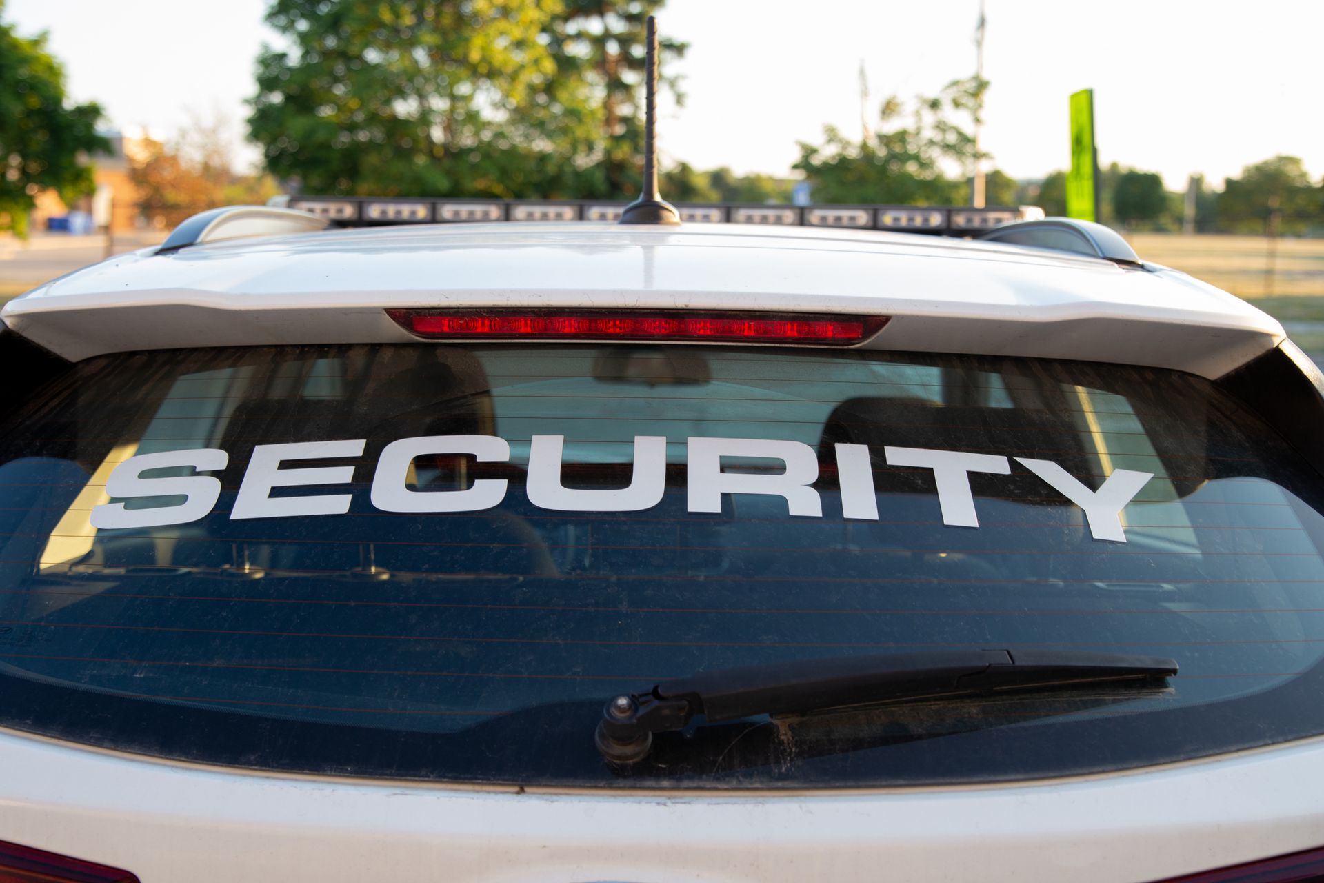 White security vehicle rear window with "SECURITY" in large, white letters.