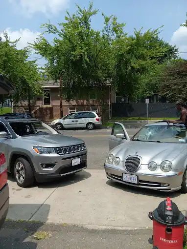 Two cars are parked on the side of the road next to a fire hydrant.