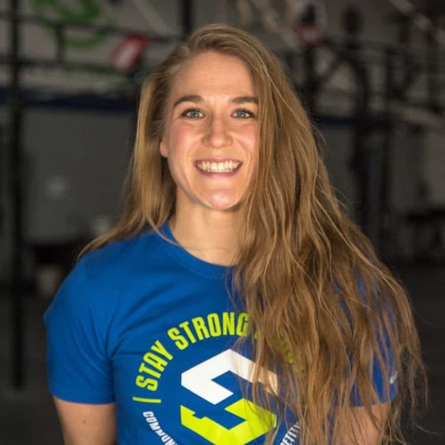 A woman wearing a blue shirt that says stay strong