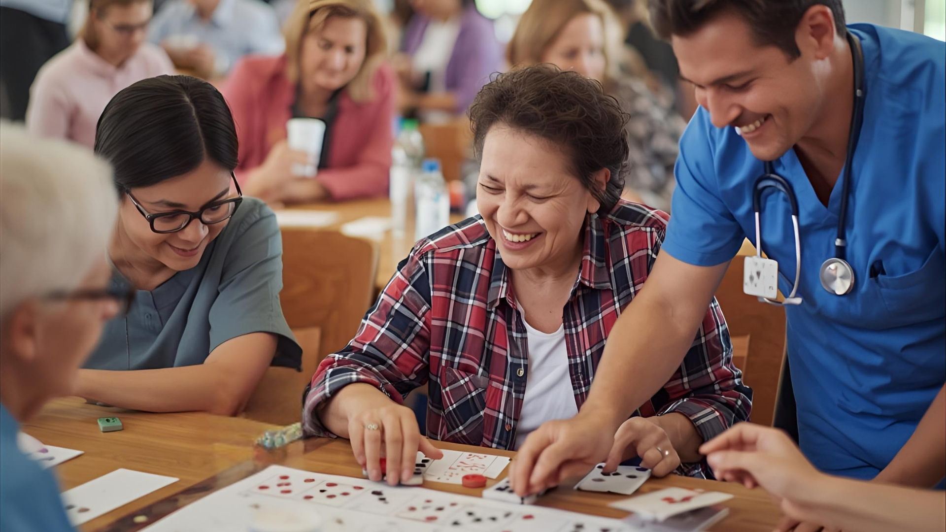 Young woman pushing an elderly woman in a wheelchair along a grassy path in a park.