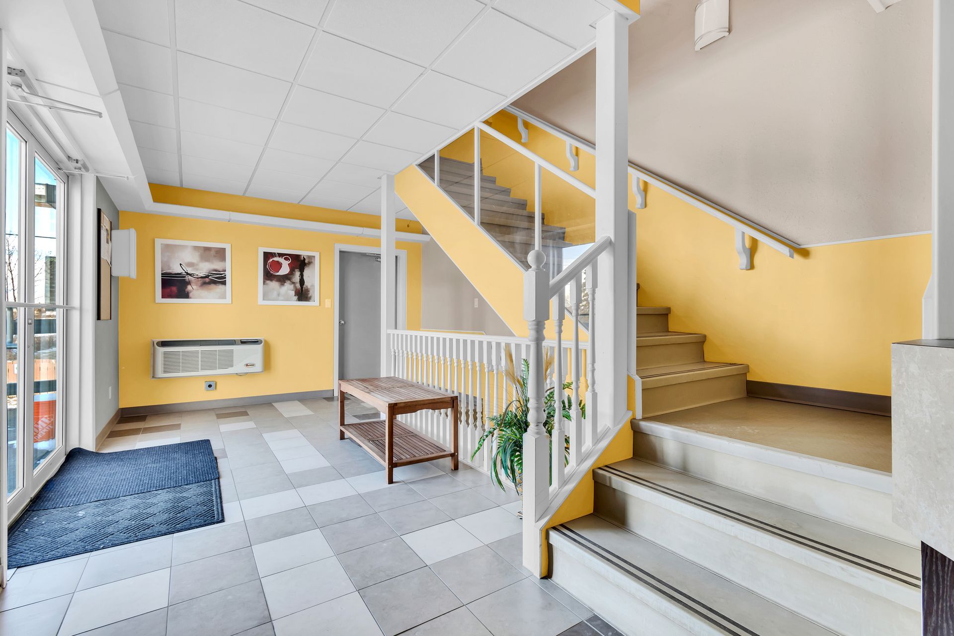 A lobby with stairs leading up to the second floor