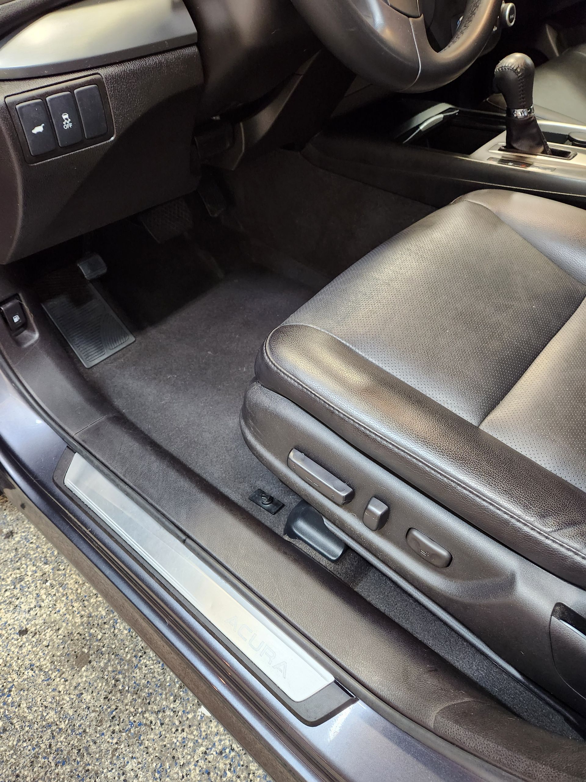 The engine of a white acura integra is shown with the hood open.