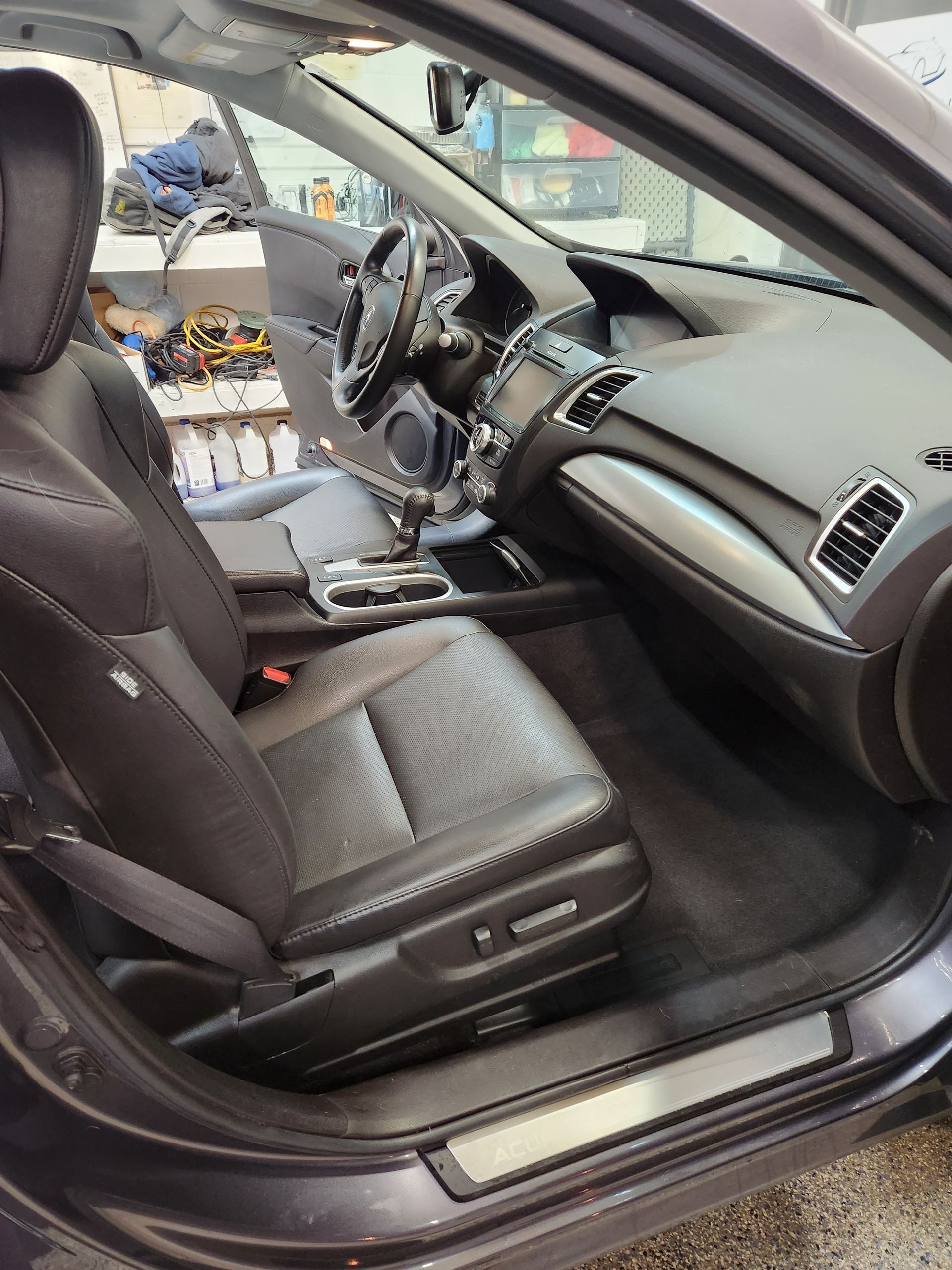 The inside of a car with the door open and the seats up