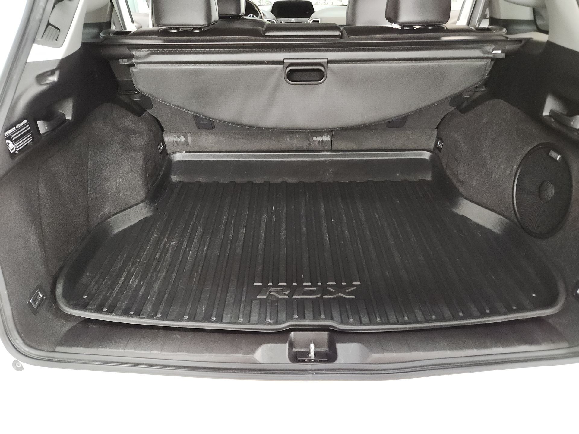 The trunk of a subaru outback with a cargo tray