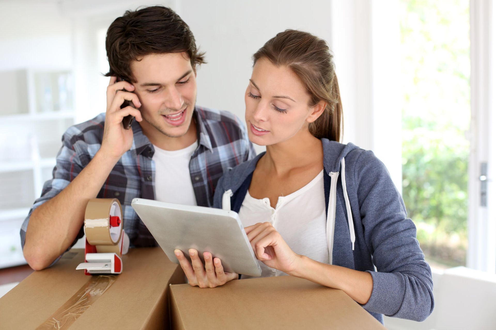 couple contacting moving company using mobile phone