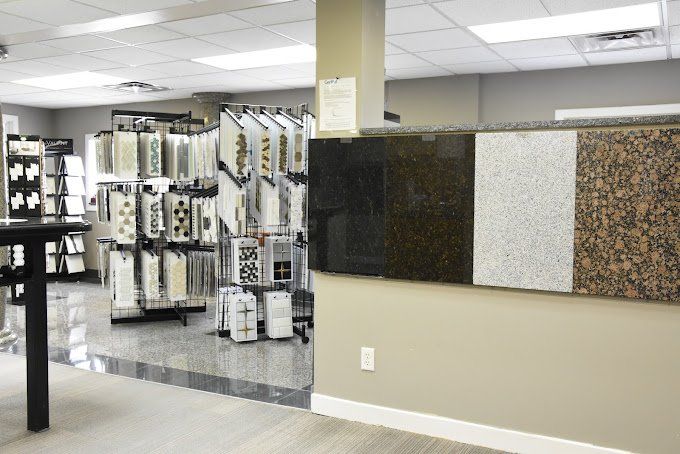 Interior of a store displaying granite samples and patterned fabric swatches for home improvement.