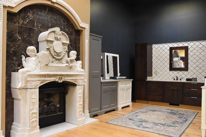 Bathroom showroom with fireplace, cabinets, and a rug.