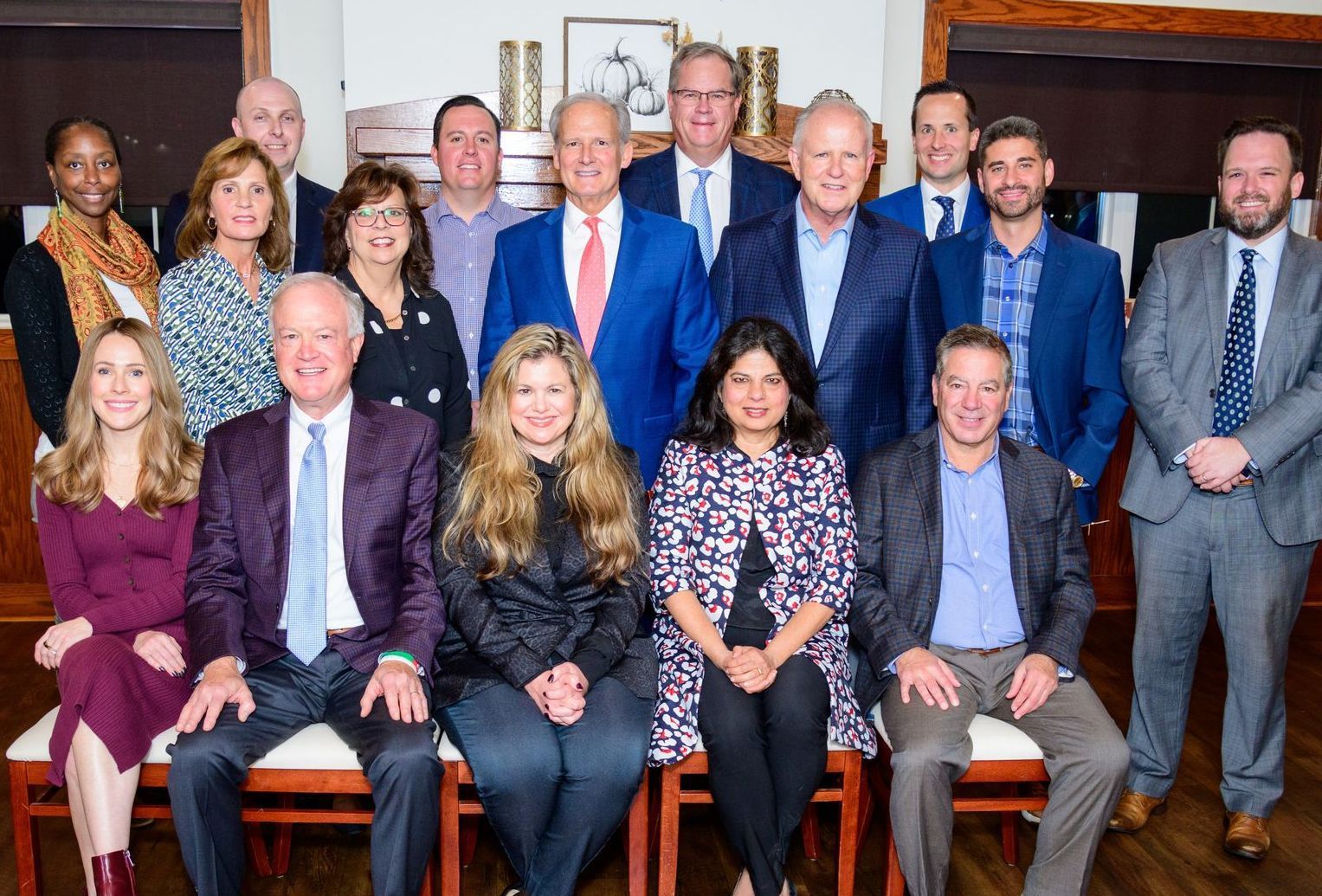 A group of people standing in front of a sign that says impact health care