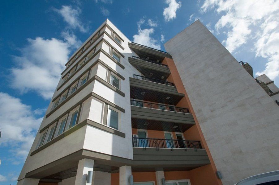 Un edificio alto con balconi e un cielo azzurro sullo sfondo
