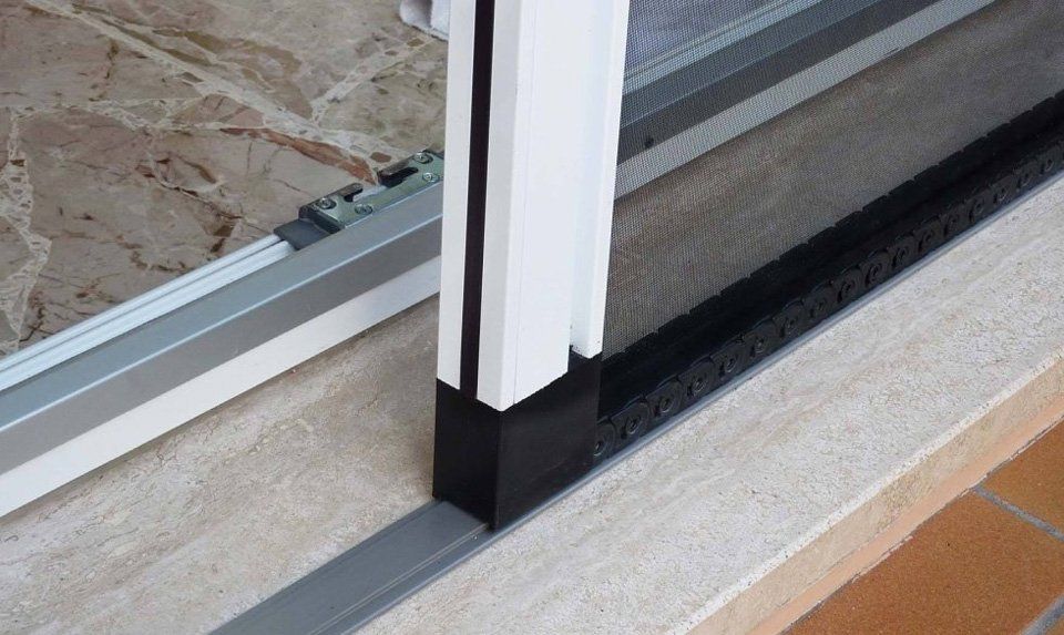 Un primo piano di una porta scorrevole in vetro con uno schermo sopra.