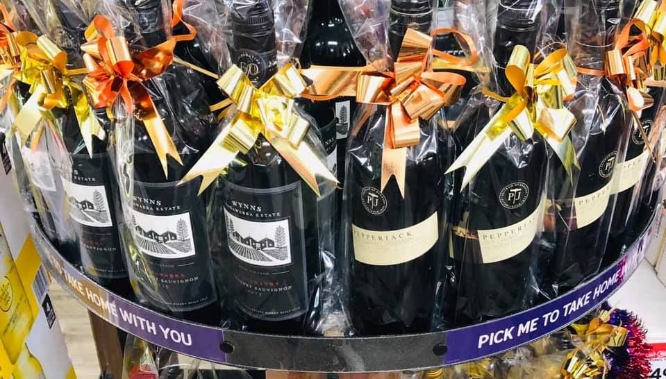 Bottles Of Wine Are Lined Up In A Wooden Box — Smith Street Supermarket In Darwin City, NT 