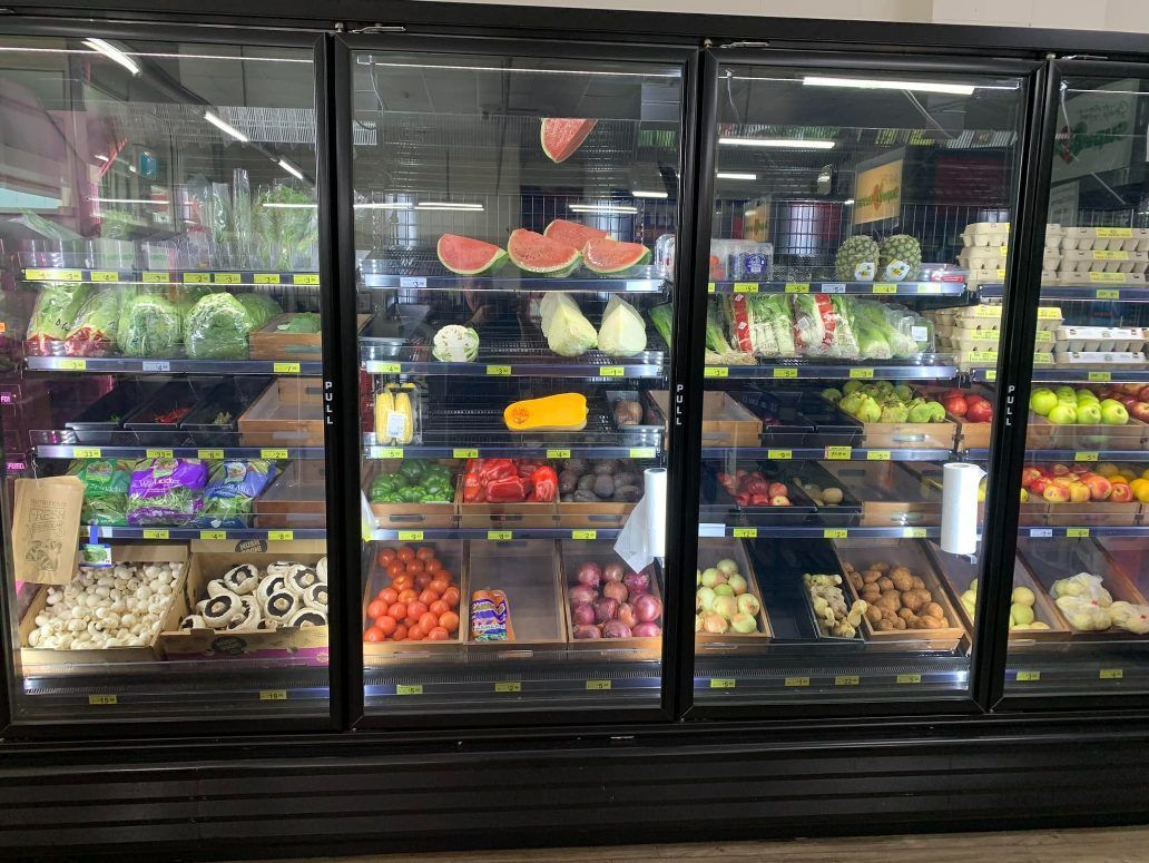A Basket Filled With Fruit And Berries On A Wooden Table — Smith Street Supermarket In Darwin City, NT 