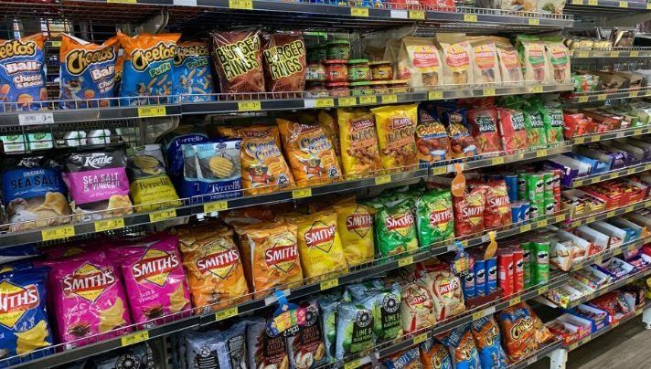 A grocery store aisle filled with lots of snacks and drinks. — Smith Street Supermarket In Darwin City, NT 