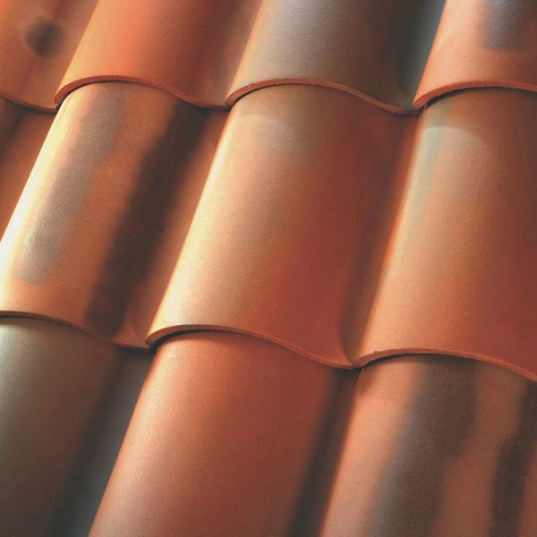 A row of concrete tiles on a roof.