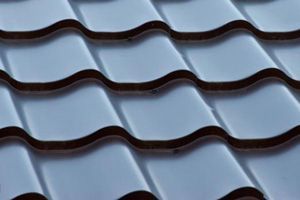 A close-up of a tile roof replacement