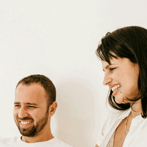 A man and a woman are standing next to each other and smiling