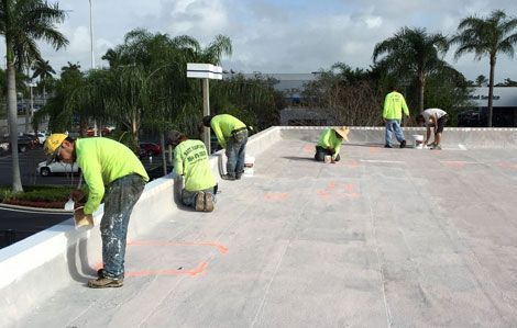 A group of construction workers are working on a roof.