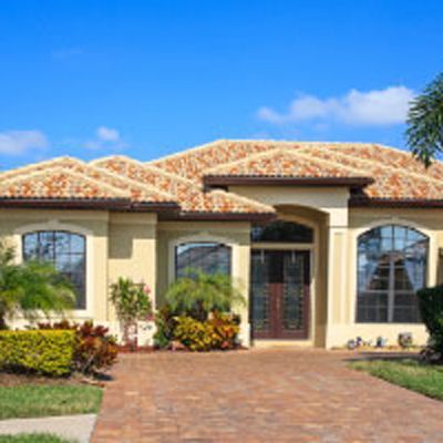 A house with palm trees in front of it